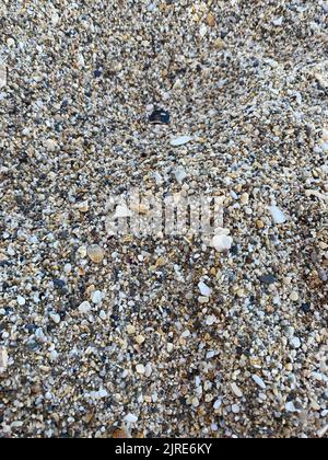 Goldener Sand Strand Textur Hintergrund an einem sonnigen Tag Stockfoto