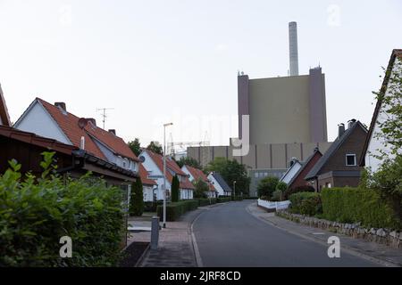 Petershagen, Deutschland. 23. August 2022. Blick auf das Kohlekraftwerk Heyden. Im Vordergrund befinden sich die Häuser der Kraftwerksiedlung. Um Erdgas zu sparen, steht ein weiteres Kohlekraftwerk aus der Reserve in Deutschland vor dem Neustart. Das ist das Heyden-Kraftwerk im Nordrhein-westfälischen Petershagen an der Grenze zu Niedersachsen. Laut Betreiber Uniper soll die Markteinführung vom kommenden Montag bis Ende April 2023 wieder aufgenommen werden. Quelle: Friso Gentsch/dpa/Alamy Live News Stockfoto