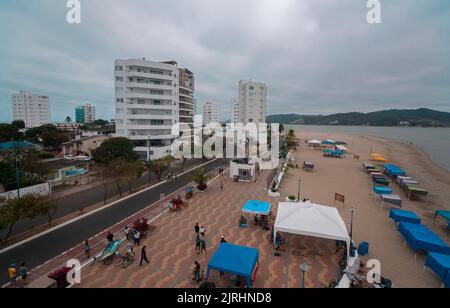 Bahia de Caraquez, Manabi / Ecuador - 21 2022. August: Menschen, die an einem bewölkten Tag auf der Strandpromenade der Stadt am Strand spazieren Stockfoto