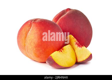 Schöne ganze Pfirsiche und zwei Scheiben auf weiß Stockfoto