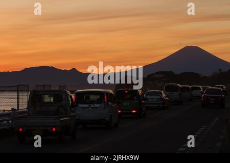 Auto auf einer Straße mit dem Berg Fuji bei Sonnenuntergang. Enoshima, Kanagawa, Japan. Stockfoto