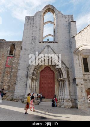 Carmo Kirche und Klosterruinen Eingang in Lissabon Portugal mit trendig gekleideten Touristen draußen. Stockfoto