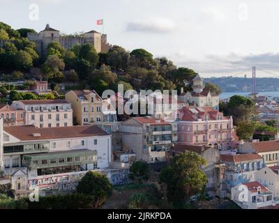 Blick vom Miradouro da Graca in Lissabon, Portugal. Schloss St. Georges (sao Jorge) links, mit Fluss Tagus und Brücke Ponte 25 de Abril im Hintergrund Stockfoto