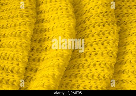 Textur aus weichem gelbem Strickstoff als Hintergrund. Banner für Design Stockfoto
