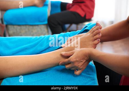 Nahaufnahme einer Frau, die eine entspannende Fußmassage genießt Stockfoto