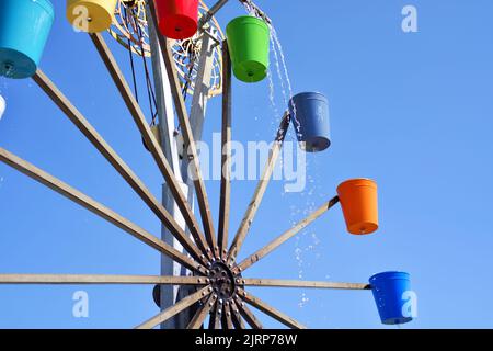 Bunte Eimer Wassermühle Stockfoto