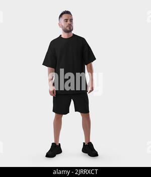 Übergroße schwarze Anzug Mockup auf einem modischen Kerl in Sneakers, T-Shirt, Shorts für Design, Druck, Muster. Männliche stilvolle Kleidung Vorlage auf bärtigen Mann Stockfoto