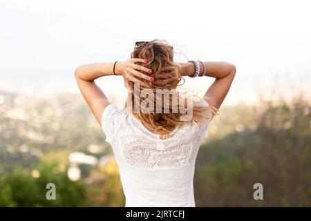 Rothaarige junge Frau mit lockigen Haaren, die den Kopf mit Kopfschmerzen hält Stockfoto