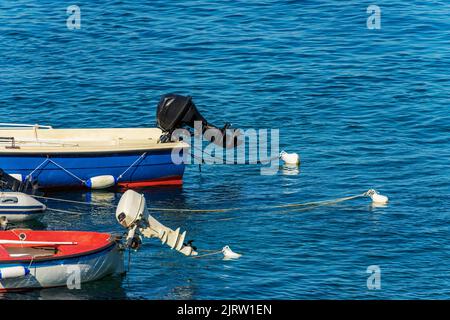 Kleine Gruppe von Außenbordmotorbooten, die im Hafen mit Bojen und Seilen festgemacht sind. Golf von La Spezia, Mittelmeer, Ligurien, Italien, Südeuropa. Stockfoto