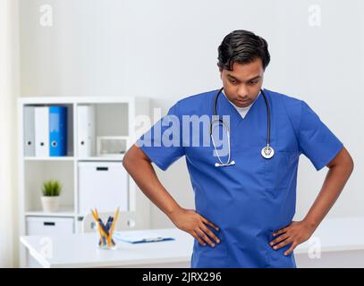 Gestresster Arzt oder Krankenschwester in blauer Uniform Stockfoto