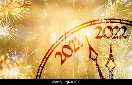 Neujahrskonzept, Uhr nahe Mitternacht 2022, Feuerwerk mit goldenem Bokeh-Hintergrund Stockfoto