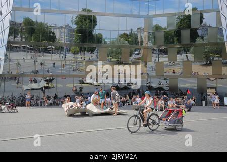 Menschen, Studenten und Radfahrer mit Kinderwagen mit Spiegelung im Glaswandfenster der Universitätsbibliothek in Freiburg, Breisgau, Süd Stockfoto