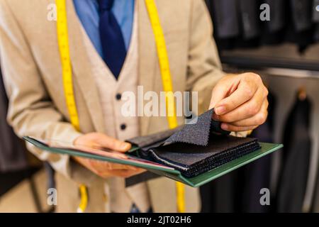 Mann in stilvollen und reichen Anzug Besitzer des Ateliers Studio beschäftigt mit der Arbeit Stockfoto