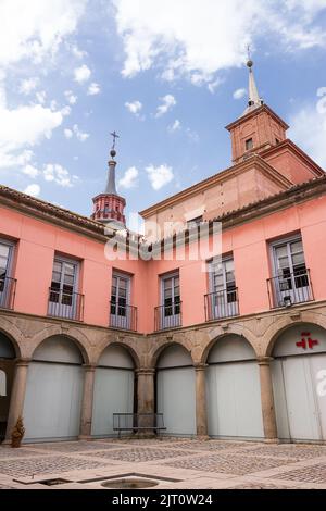 Alcalá de Henares, Spanien - 18. Juni 2022: Innenhof des Cervantes-Instituts von Alcalà de Henares und im Hintergrund die Glockentürme Stockfoto