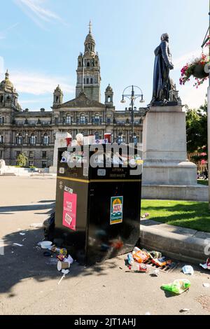 27. August 2022, Glasgow, Großbritannien. Während der Arbeitskonflikt zwischen den GEWERKSCHAFTEN UNITE, COSLA und GMB, die die am niedrigsten bezahlten Mitarbeiter der örtlichen Behörden vertreten, anhält, Mülltonnen und Sammelgebiete im Stadtzentrum von Glasgow sind überfüllt, und laut Public Health Scotland ist die öffentliche Gesundheit jetzt aufgrund von Ungeziefer und anderen giftigen Schadstoffen ernsthaft gefährdet. Bild am George Square mit den City Chambers dahinter. Kredit: Findlay/ Alamy Live Nachrichten Stockfoto