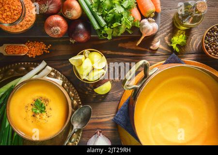 Arabische Küche; traditionelle rote Linsensuppe aus dem Nahen Osten mit frischen Zutaten. Stockfoto