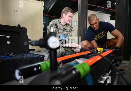 Der Techniker der U.S. Navy für explosive Ordnance Disposal (EOD), Klasse 2., und der Techniker der EOD, Klasse 3., sind beide einem Minenabhilfeteam mit Commander, Task Group (CTG) 140209 zugewiesen Stockfoto