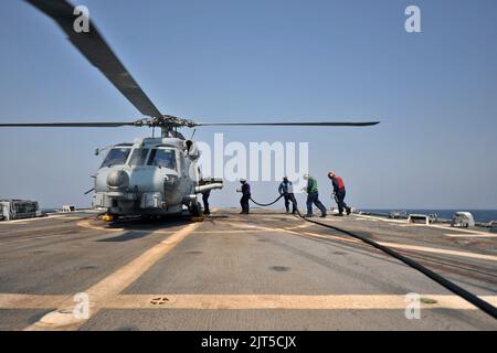 US-Matrosen bereiten sich darauf vor, einen MH-60R Seahawk-Hubschrauber, der am Hubschrauber Maritime Strike Squadron (HSM) 70 an Bord des Lenkflugkörper-Zerstörers USS Truxtun (DDG 103) befestigt ist, im Arabischen Meer am 110917. September zu betanken Stockfoto