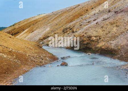 Heißer Schwefelwasserstoff-Strom zwischen den Ufern von Vulkanasche und Tephra in der Caldera des Vulkans Golovnin, Insel Kunashir Stockfoto