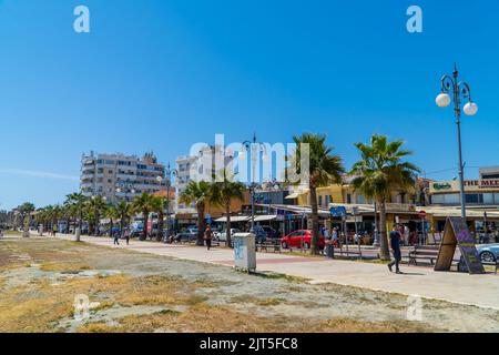 Larnaca, Zypern - 22. April 2022 - Finikoudes Strandpromenade im Sommer unter blauem Himmel Stockfoto