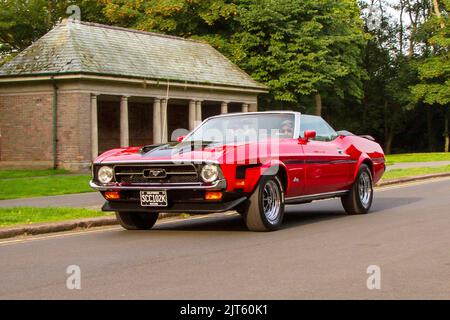 1972 70s Siebziger Red FORD Mustang 5700cc Petrol Pony Car; Ankunft bei der jährlichen Stanley Park Classic Car Show in den italienischen Gärten. Stanley Park Classics Yesteryear Motor Show, veranstaltet von Blackpool Vintage Vehicle Preservation Group, Großbritannien. Stockfoto