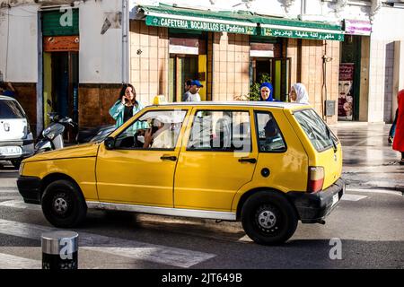 Tetouan, Marokko - 17. August 2022 Taxi fährt durch die Straßen von Tetouan während des Coronavirus-Ausbruchs trifft Marokko, trägt eine Maske ist mand Stockfoto
