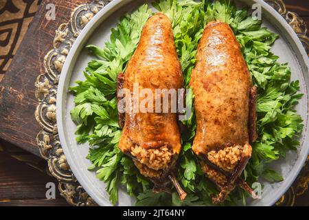 Arabische Küche, traditionelle ägyptische gefüllte Tauben oder Hamam Mahshi-Gericht. Nahaufnahme mit Kopierbereich. Stockfoto