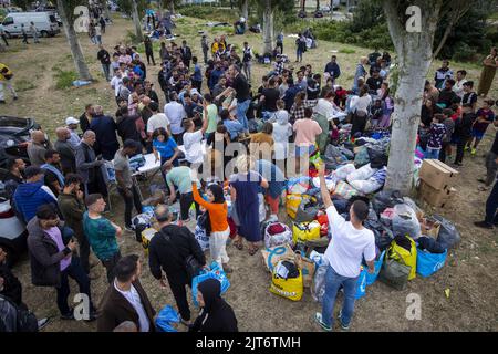 Ter Apel, Niederlande. 28. August 2022. 2022-08-28 16:43:13 TER APEL - Freiwillige der Islamischen Gemeinschaft Milli Gorus aus Rotterdam geben im Antragszentrum in Ter Apel Hilfsgegenstände an Asylbewerber aus. Hunderte Flüchtlinge bleiben seit Tagen außerhalb des Antragszentrums. ANP VINCENT JANNINK netherlands Out - belgium Out Credit: ANP/Alamy Live News Stockfoto