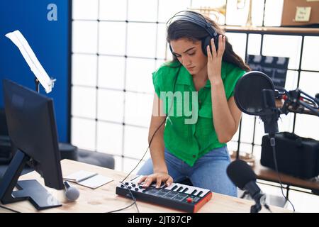 Junge hispanische Musikerin mit dj-Session im Musikstudio Stockfoto