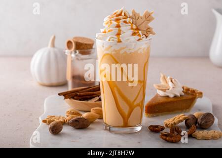 Kürbiskuchen-Milchshake mit Karamellsirup und Schlagsahne Stockfoto