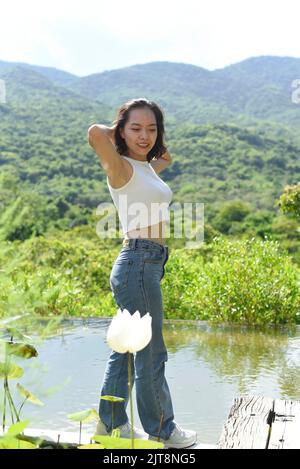 Junge Vietnamesin, die in einem Park spazieren geht Stockfoto