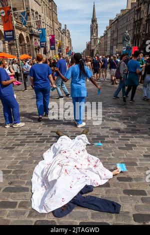 Darsteller, die ihre Show auf der Royal Mile während des Edinburgh Fringe Festivals bewerben. Stockfoto