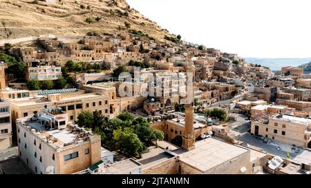 Luftdrohnenansicht zu den Straßen der antiken Stadt Mardin, Mesopotamien, Türkei. Mardin Stadtbild mit Dächern und Minaretten in der Altstadt Stockfoto