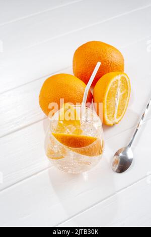 Kalte frische Orangenlimonade auf hellem Holzhintergrund Stockfoto