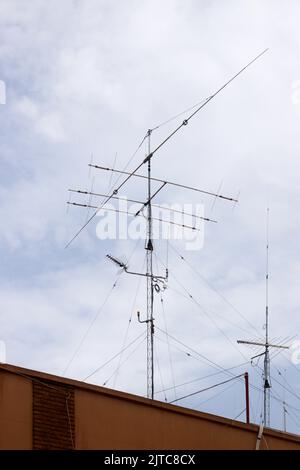 Nahaufnahme einer Amateurfunkantenne, die auf einem hohen Gebäude in einer Stadt installiert ist, um Funksignale auszustrahlen und zu empfangen Stockfoto