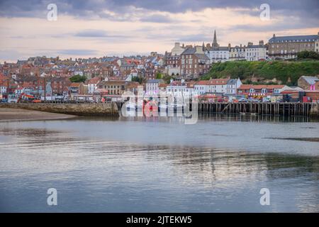 Der Fluss Esk fließt am Abend durch den Hafen von Whitby. Stockfoto