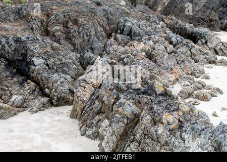 Freiliegendes Gestein ragt über sandigen Boden. Wunderschöne Felsen. Stockfoto