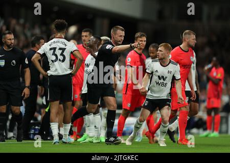 Craven Cottage, Fulham, London, Großbritannien. 30. August 2022. Premier League Football, Fulham gegen Brighton: Schiedsrichter Thomas Bramall vergibt Brighton eine Strafe, nachdem er sich mit dem VAR-System bewogen hat.Credit: Action Plus Sports/Alamy Live News Stockfoto