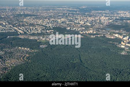 Luftbild Foto aus dem Flugzeug der Stadt und klaren Himmel. Luftaufnahmen der großen Stadt aus einem Flugzeugfenster. Blick auf die moderne Stadt aus Flugzeug gewinnen Stockfoto