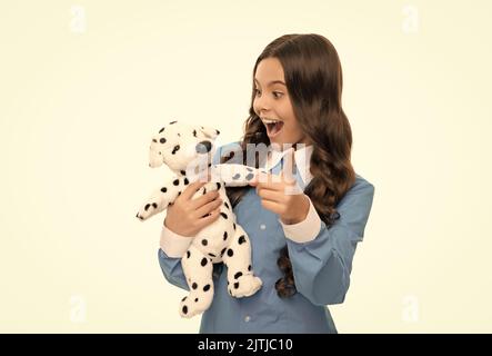 Überrascht Kind Porträt hat lange lockiges Haar Spiel mit Spielzeug Hund isoliert auf weiß, zukünftige Karriere Stockfoto