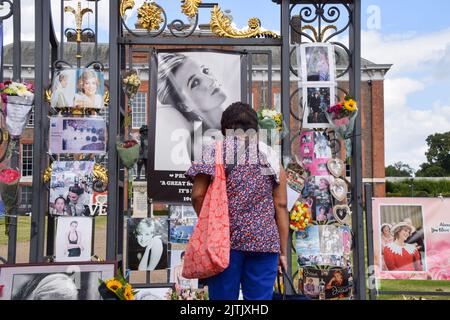 London, Großbritannien. 31.. August 2022. Eine Frau schaut sich die Ehrungen vor dem Kensington Palace zum 25.. Todestag von Prinzessin Diana an. Kredit: Vuk Valcic/Alamy Live Nachrichten Stockfoto