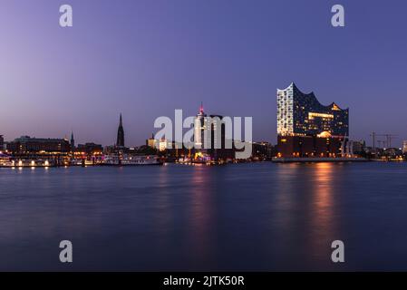 Die Elbe-Philharmonie im Hamburger Hafen leuchtet in der goldenen Stunde der Dämmerung, Hamburg, Deutschland Stockfoto