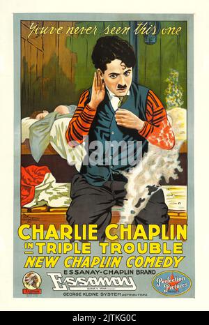 Charlie Chaplin, Vintage Filmplakat - Triple Trouble (Essanay, 1918). Ein Blatt Stockfoto