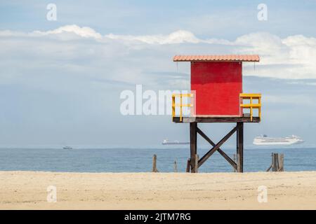 Roter Rettungsschwimmer am strand copacabana mit dem Meer im Hintergrund und dem blauen Himmel in rio de janeiro Brasilien. Stockfoto