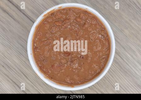 Der Blick von oben auf das mexikanische Essen benötigt eine Beilage authentischer, wiedergebratener Bohnen, um den Geschmack des Essens zu vervollständigen. Stockfoto