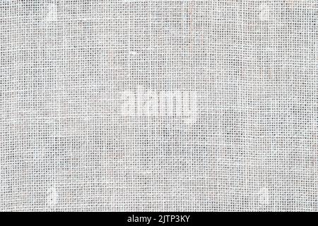 Quappen-Textur, Leinentuch, hellgrau gewebte rustikale Absackung. Natürliche hessische Jute, textile Textur. Weißes Leinenmuster. Threads Hintergrund. Stockfoto