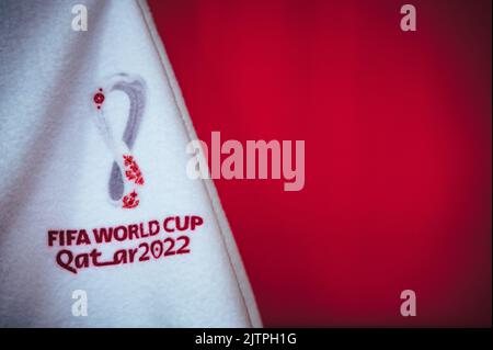 DOHA, KATAR, 30. AUGUST 2022: Logo der Fußball-Weltmeisterschaft 2022 in Katar. Fußball-Weltmeisterschaft. Roter Hintergrund und Bearbeitungsraum für Ihre Montage Stockfoto