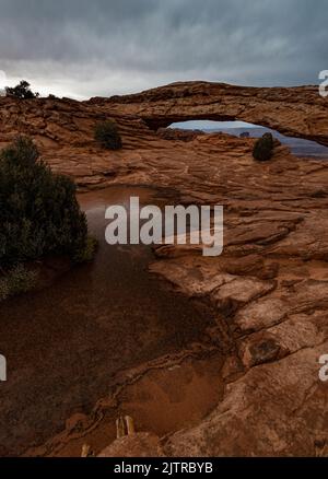 Über dem Mesa Arch im Canyonlands National Park, San Juan County, Utah, sammeln sich Sturmwolken Stockfoto