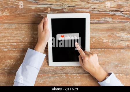 Nahaufnahme der Hand mit Spendensymbol auf dem Tablet-pc Stockfoto