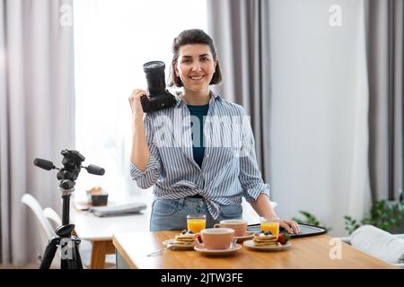 Essensfotograf mit Kamera in der Küche Stockfoto